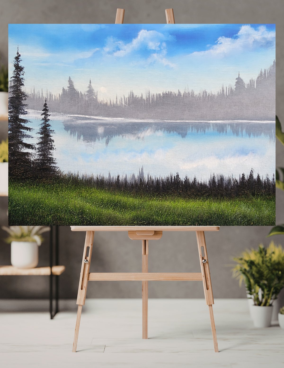 Bob Ross-style oil painting on an easel — misty lake and pine forest