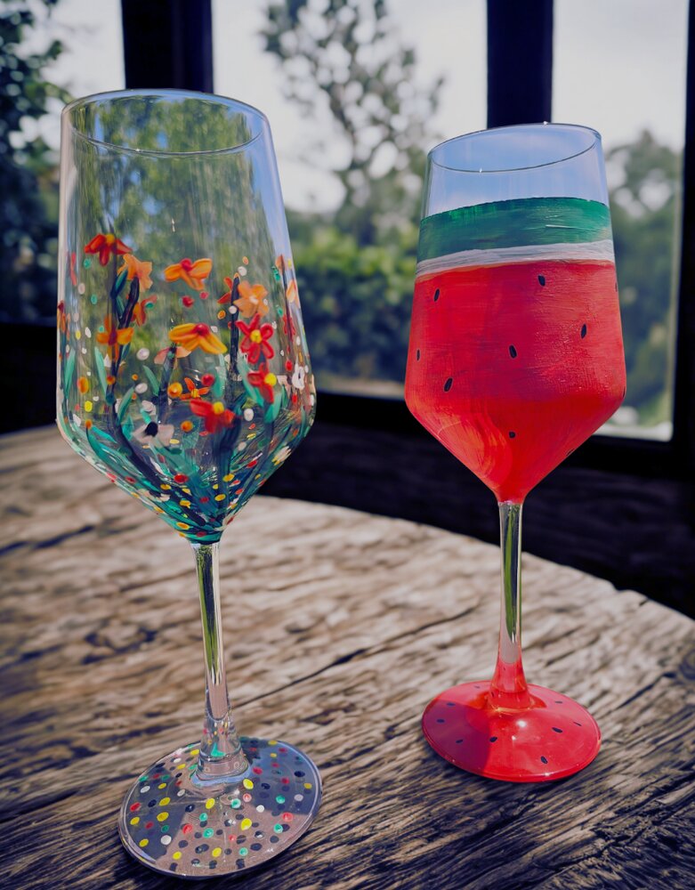 Two hand-painted wine glasses — floral and watermelon designs